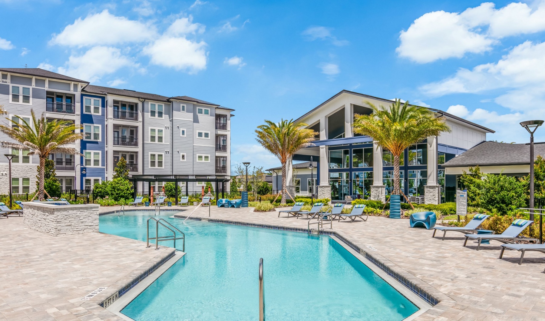 Pool Deck and Clubhouse + Building Exterior at Integra Park at Oakleaf